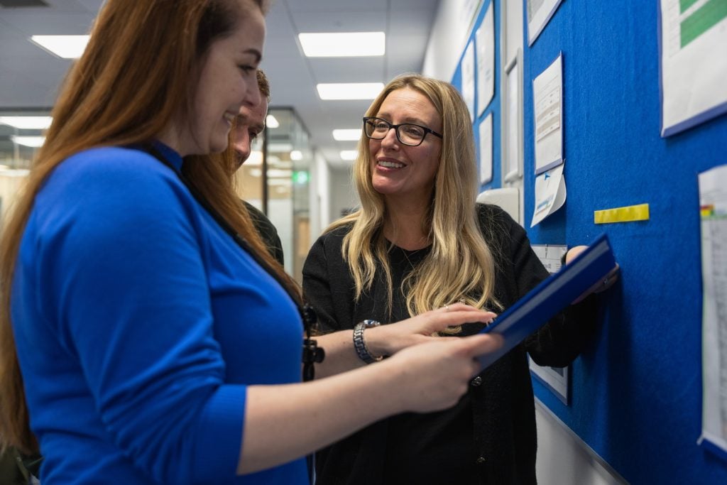Barclay employees discussing in front of a presentation board